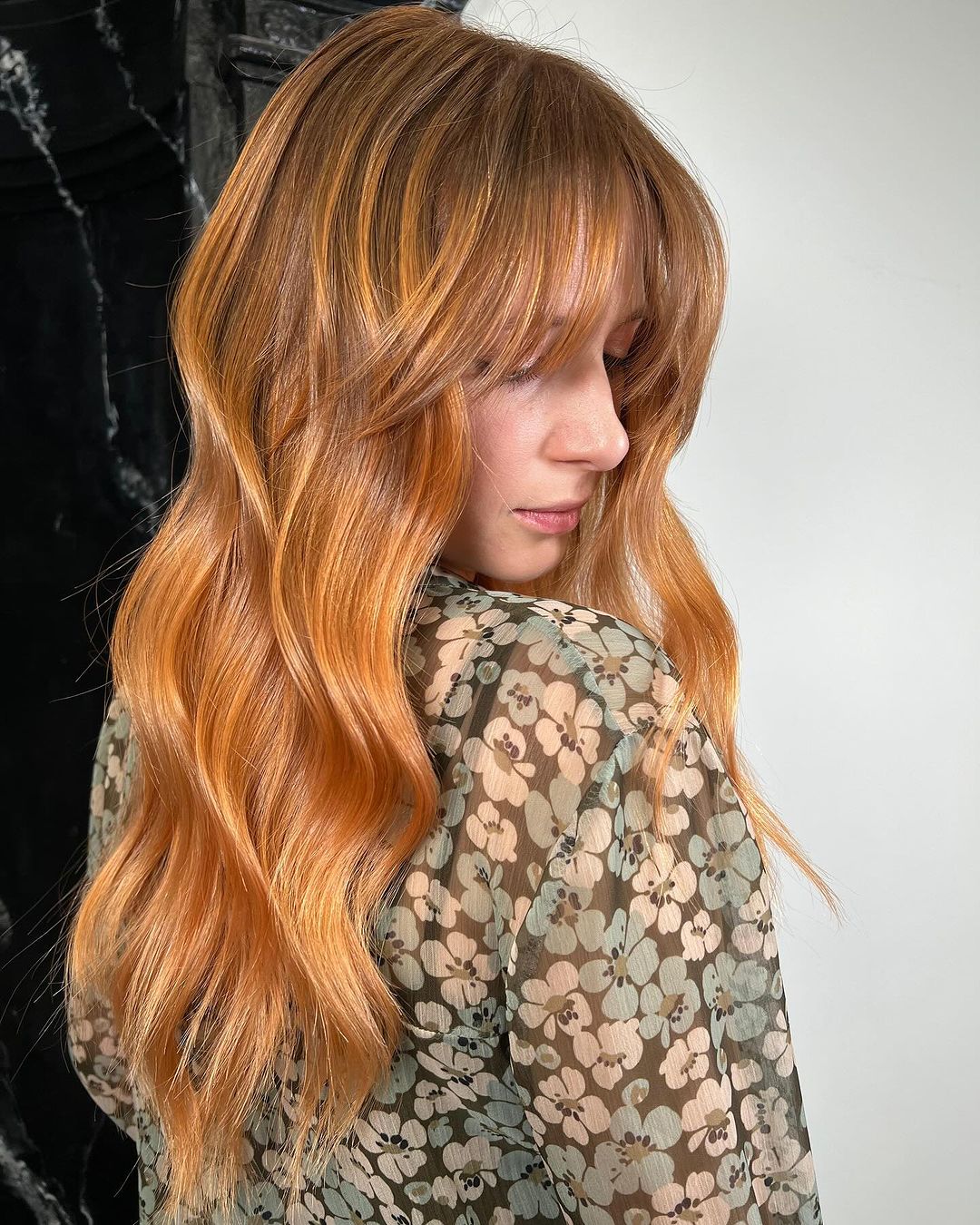 light auburn balayage with layered bangs