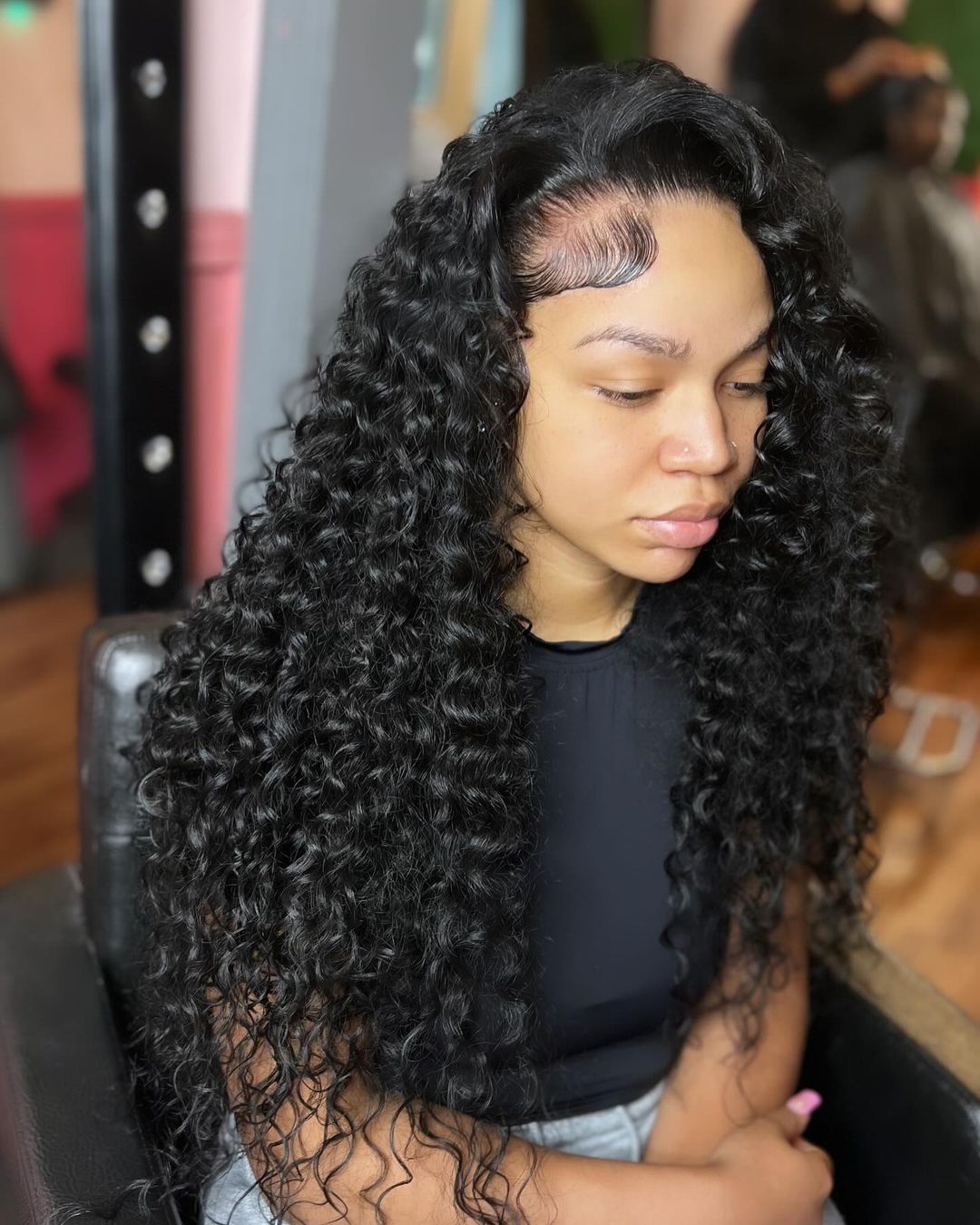 long curly quick weave with a deep side part