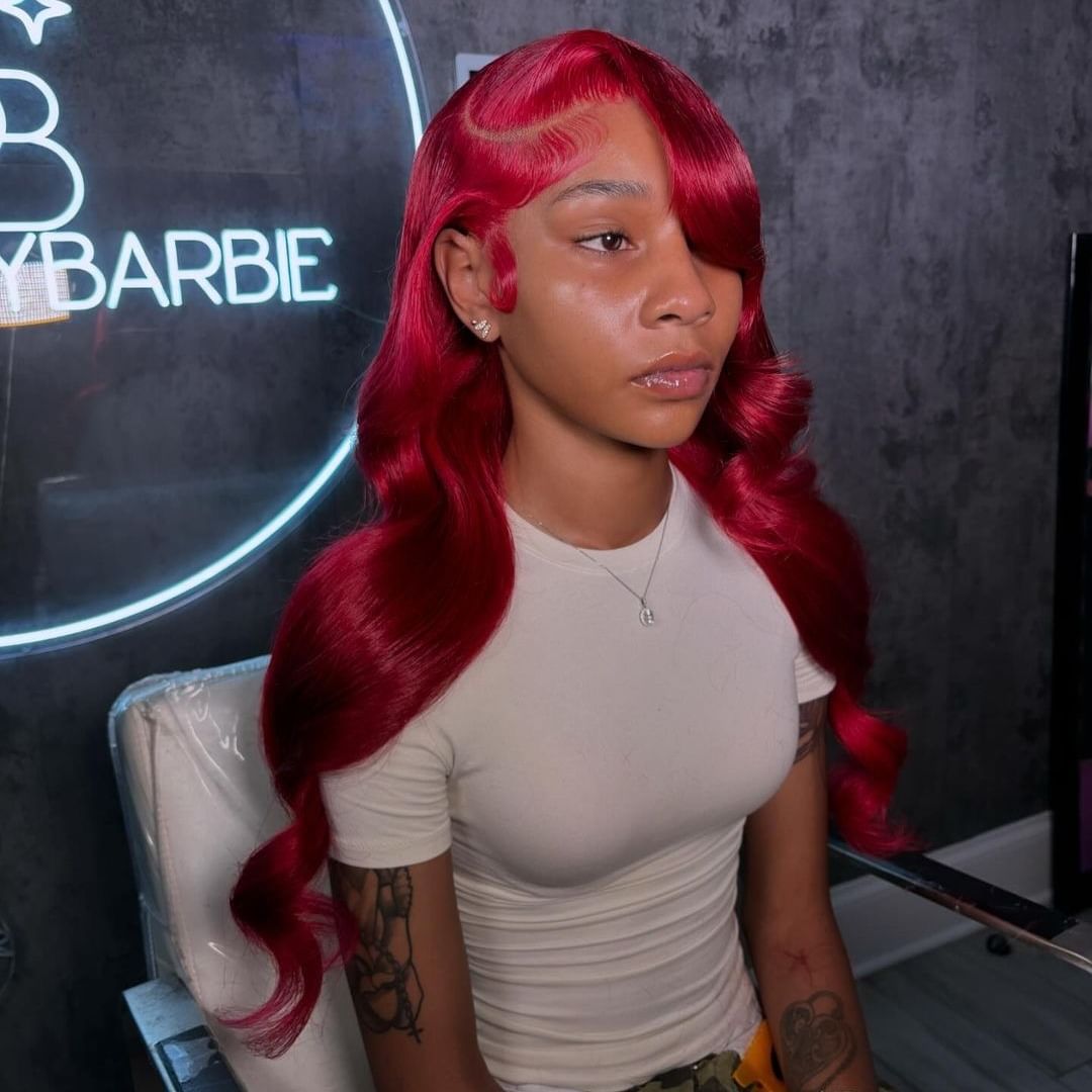 red weave glam wave hairstyle with a deep side part