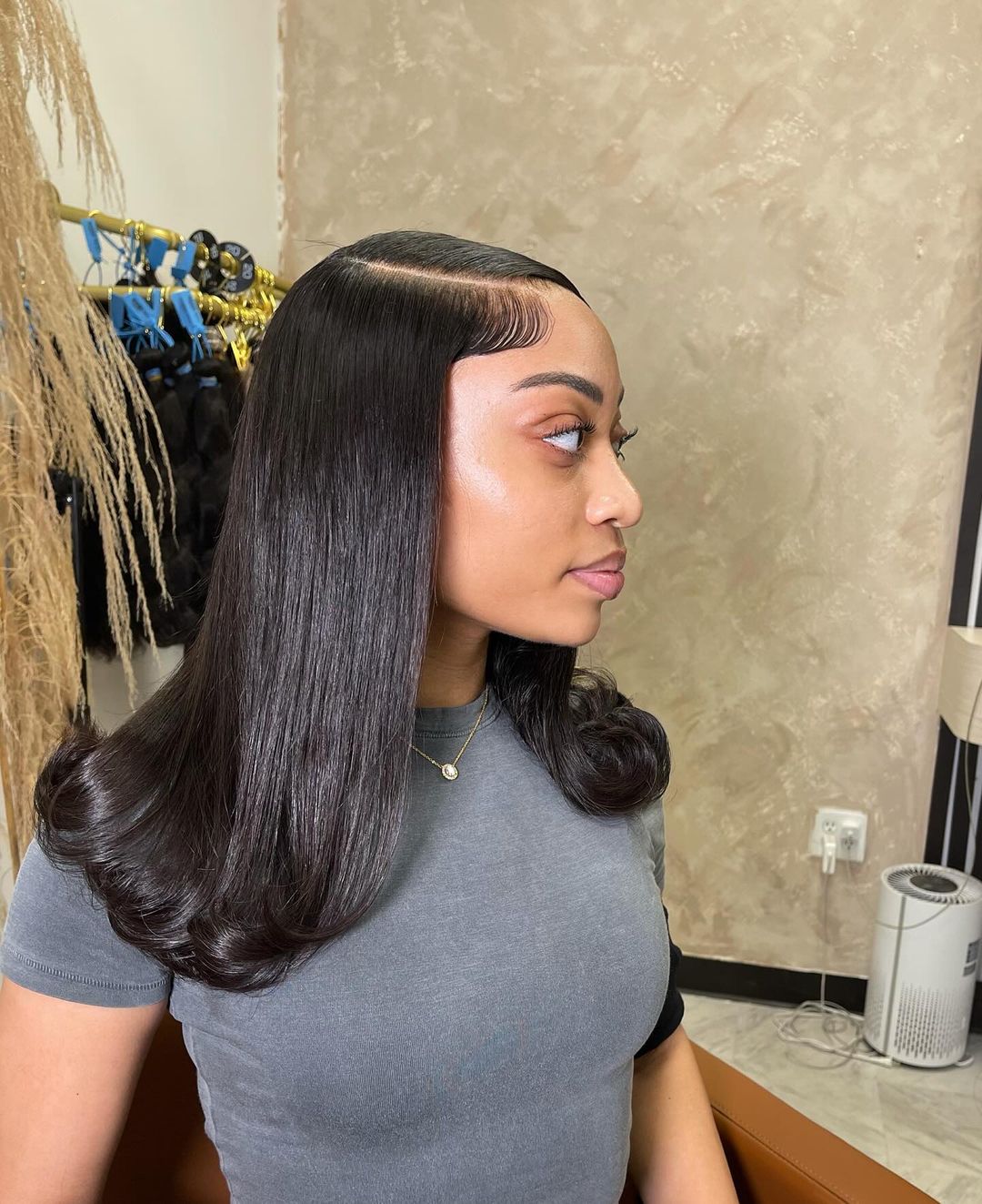 sleek straight quick weave with a deep side part