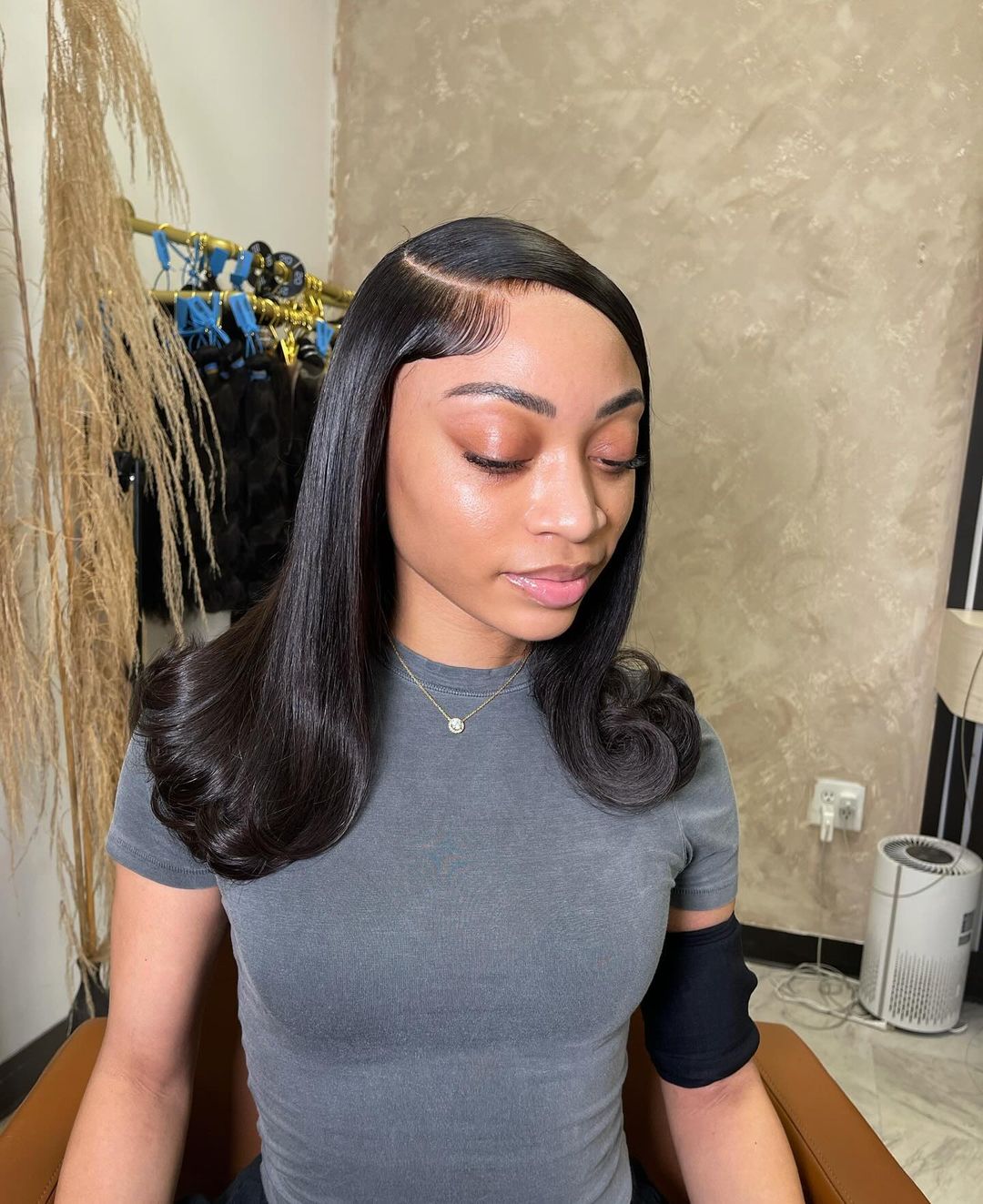 sleek straight quick weave with a deep side part