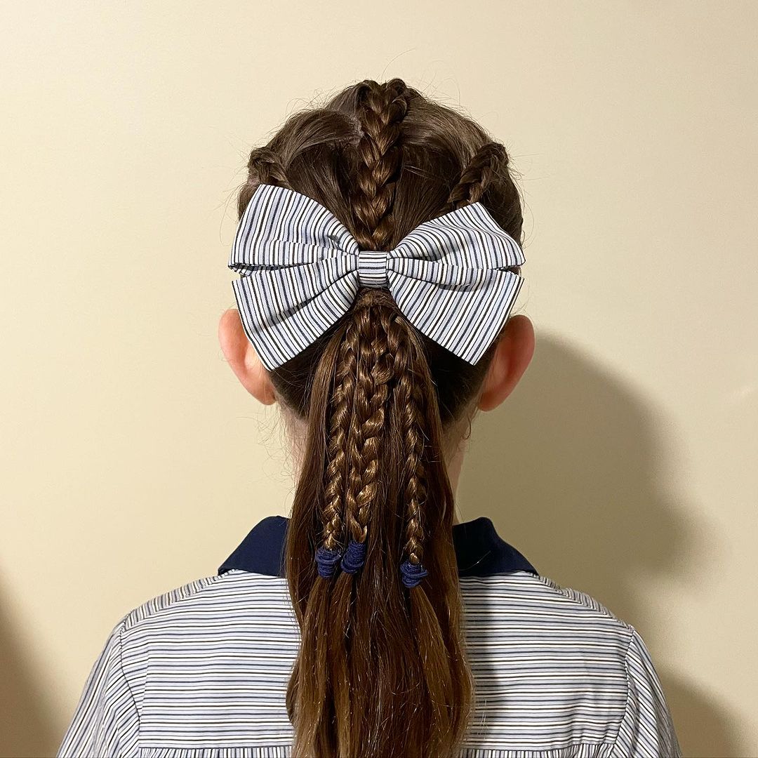 two dutch braids and a french braid on top into a pony