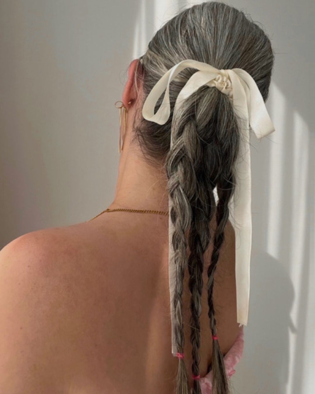 braided ponytail style with a bow