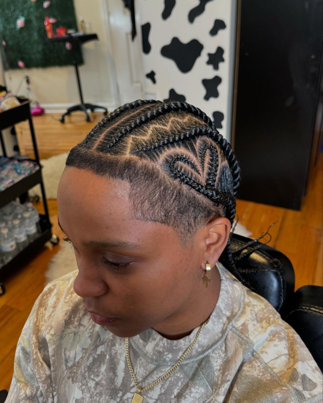 cornrows with shaved sides and a zig zag parting