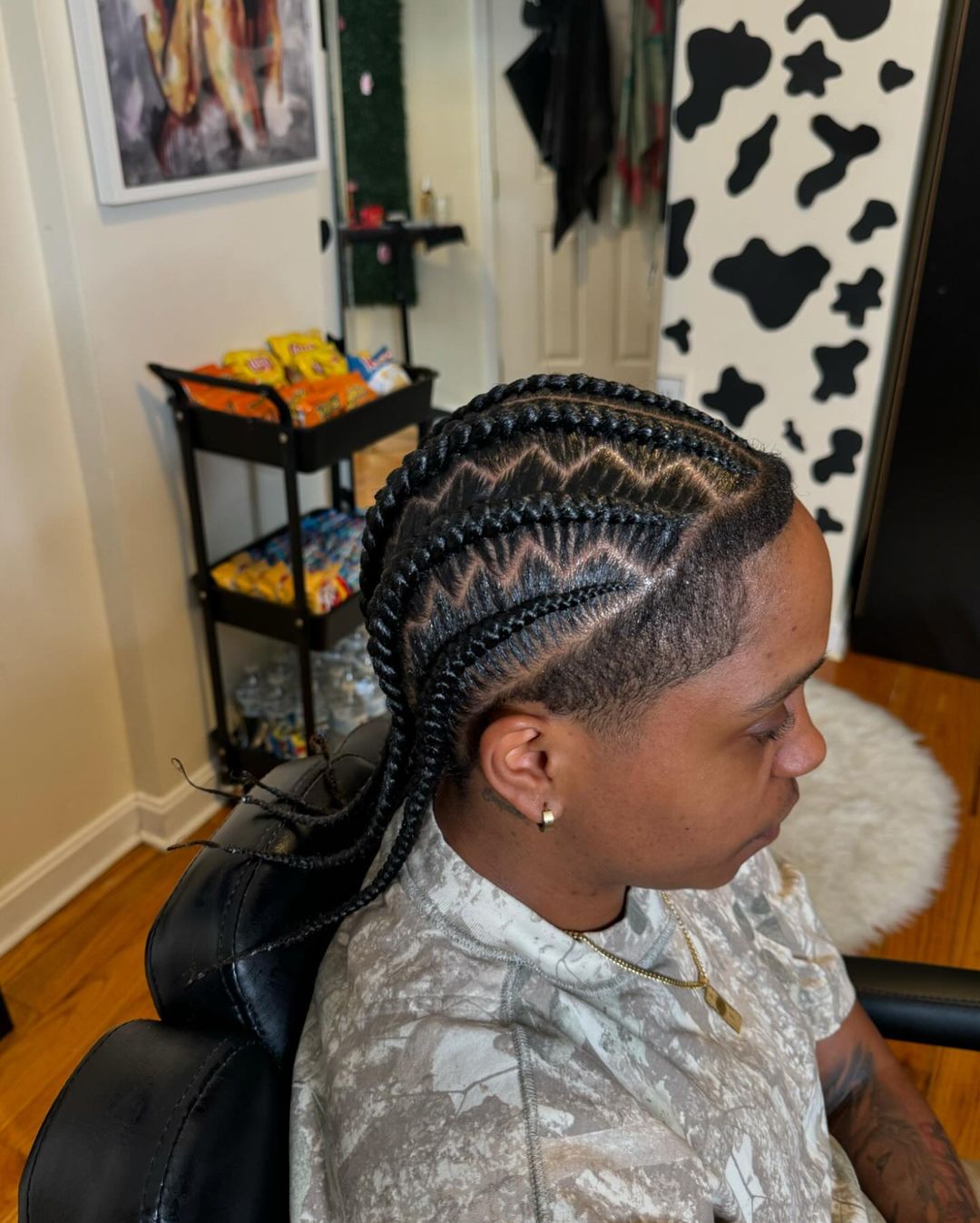 cornrows with shaved sides and a zig zag parting