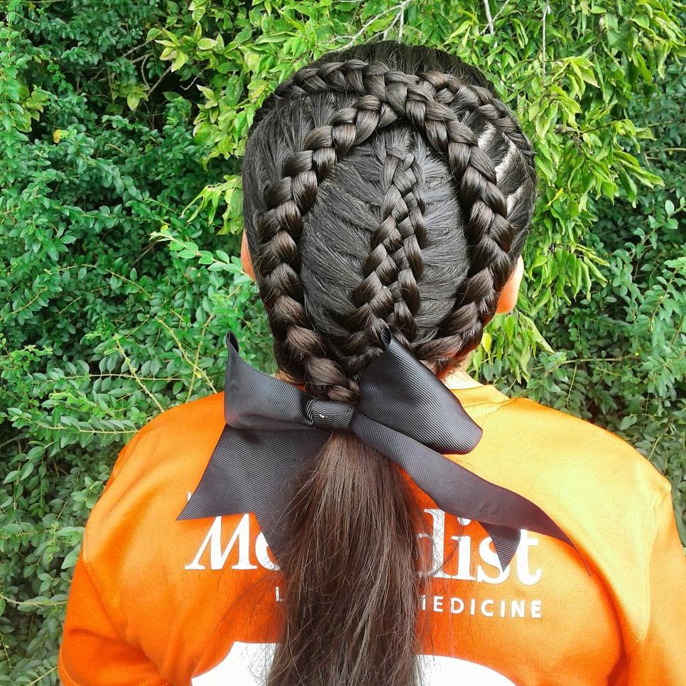 criss crossed lace Dutch braids with a middle 5-strand Dutch braid ponytail with a bow