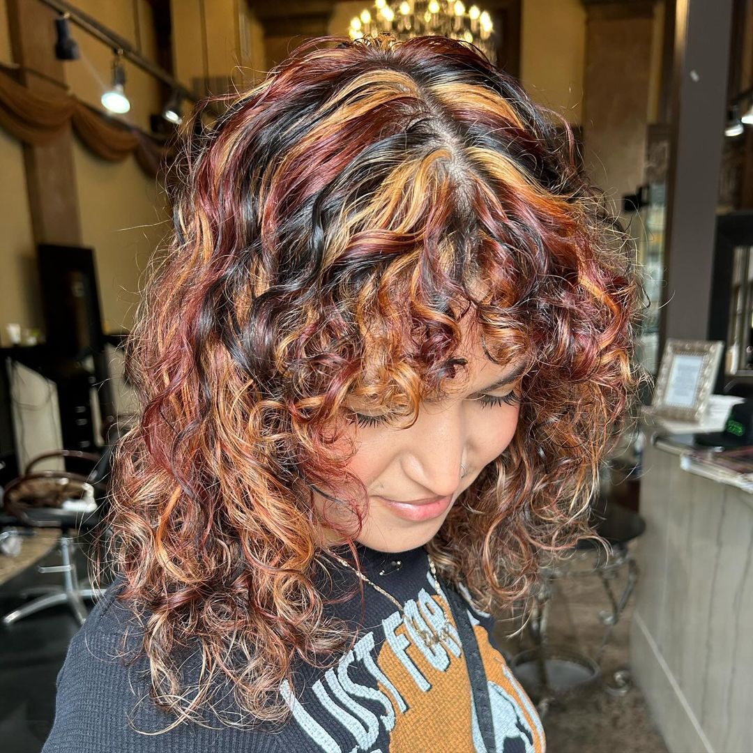 curly dark calico hair with chunky highlights