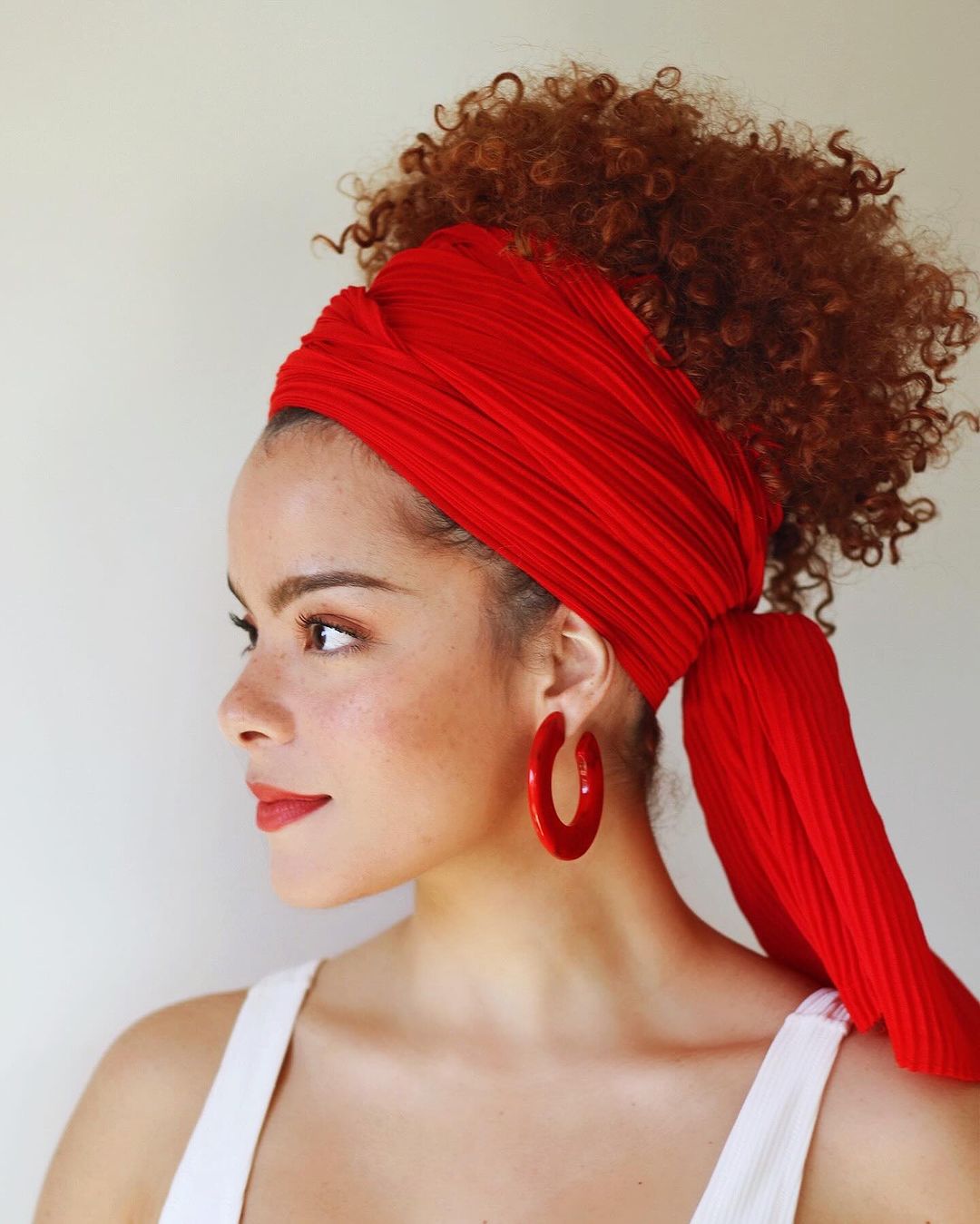 curly messy bun with a headscarf