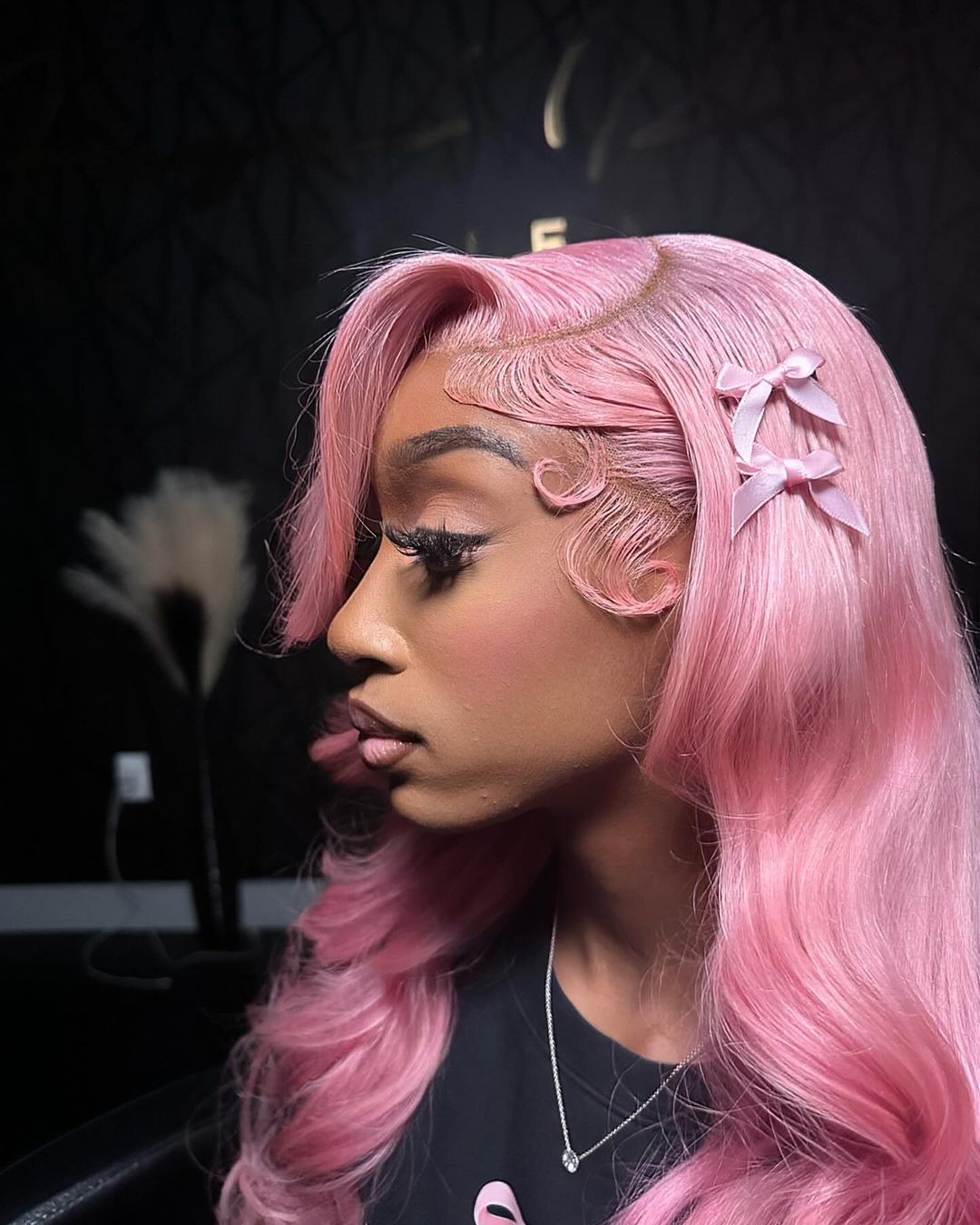 pastel pink side part quick weave with bows