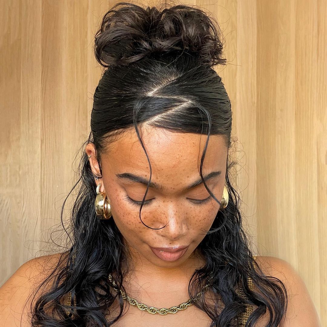 sleek curly bun with a zig zag parting