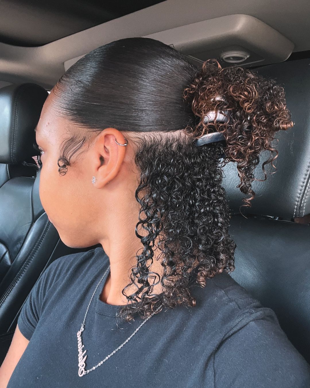 sleek curly claw clip half-up hairstyle