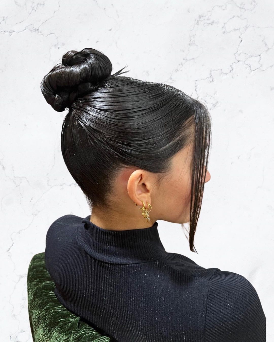 sleek top knot with face-framing pieces