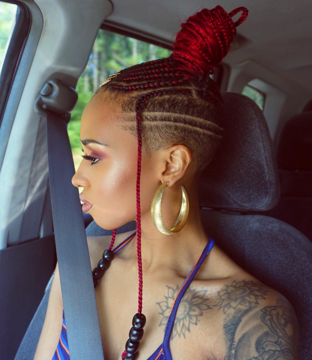 vivid red ombre braids with freestyle shaved design