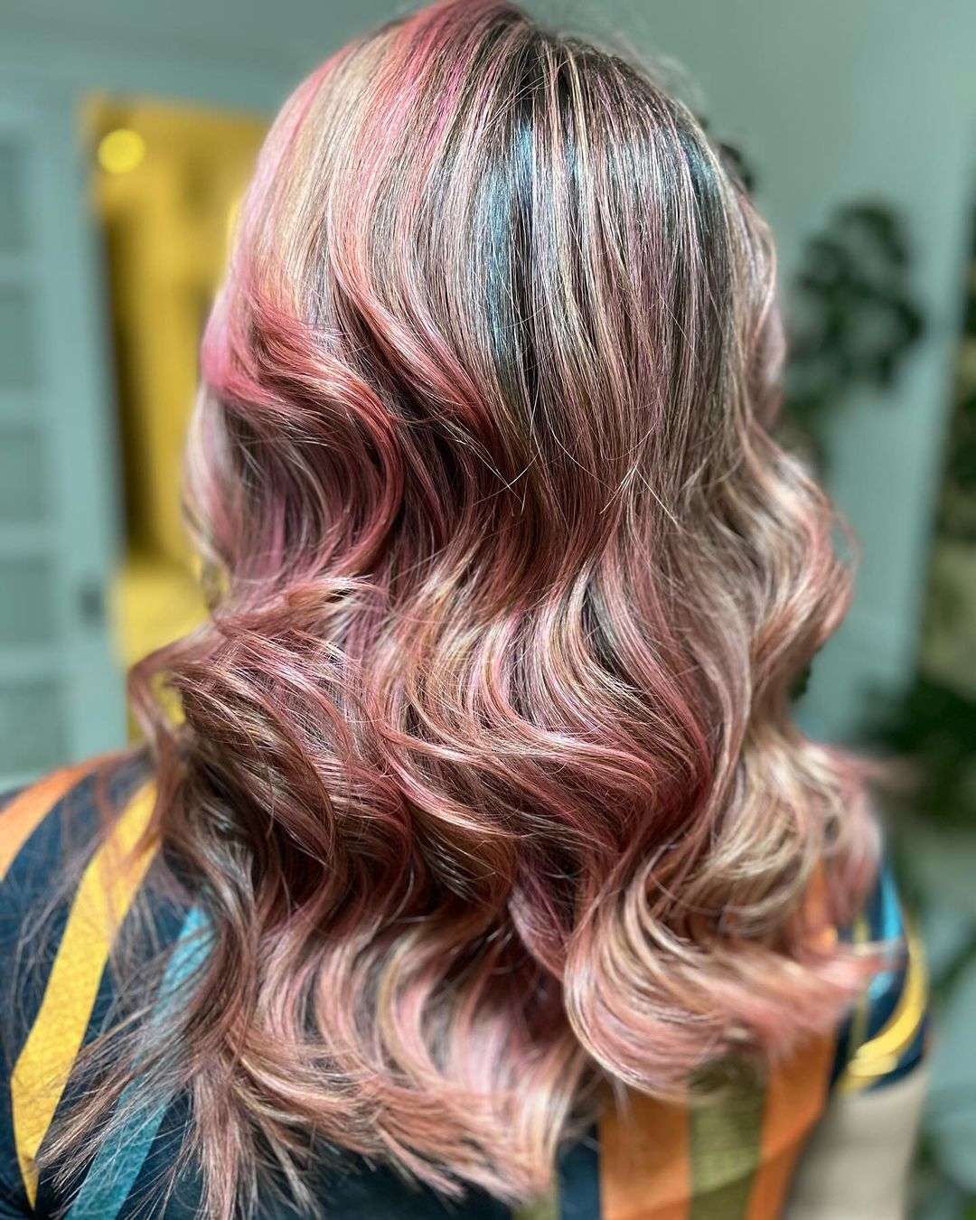 vivid rose gold highlights on brown hair