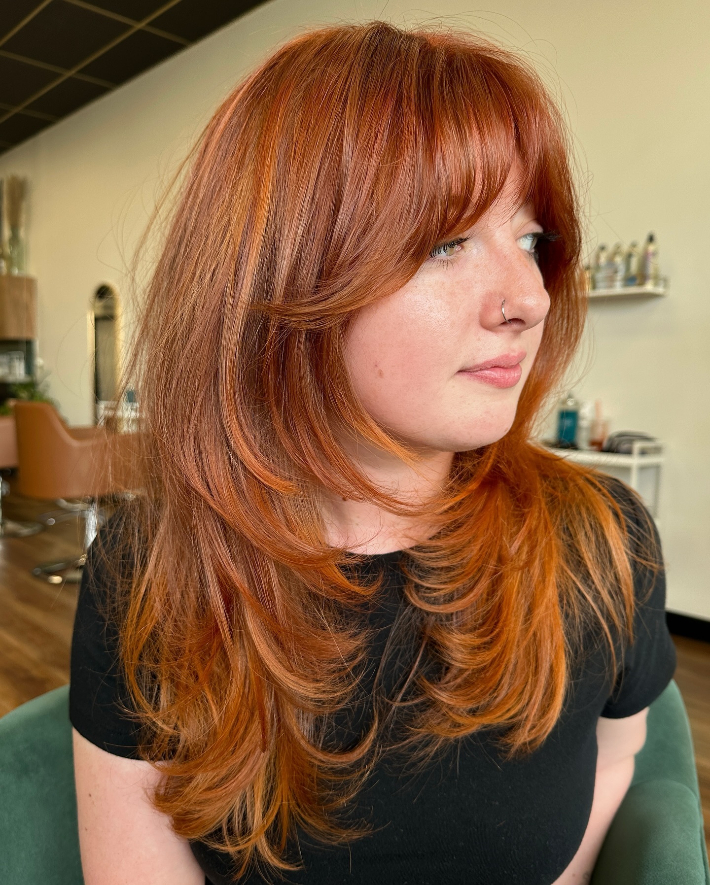 light copper brown hair with curtain bangs