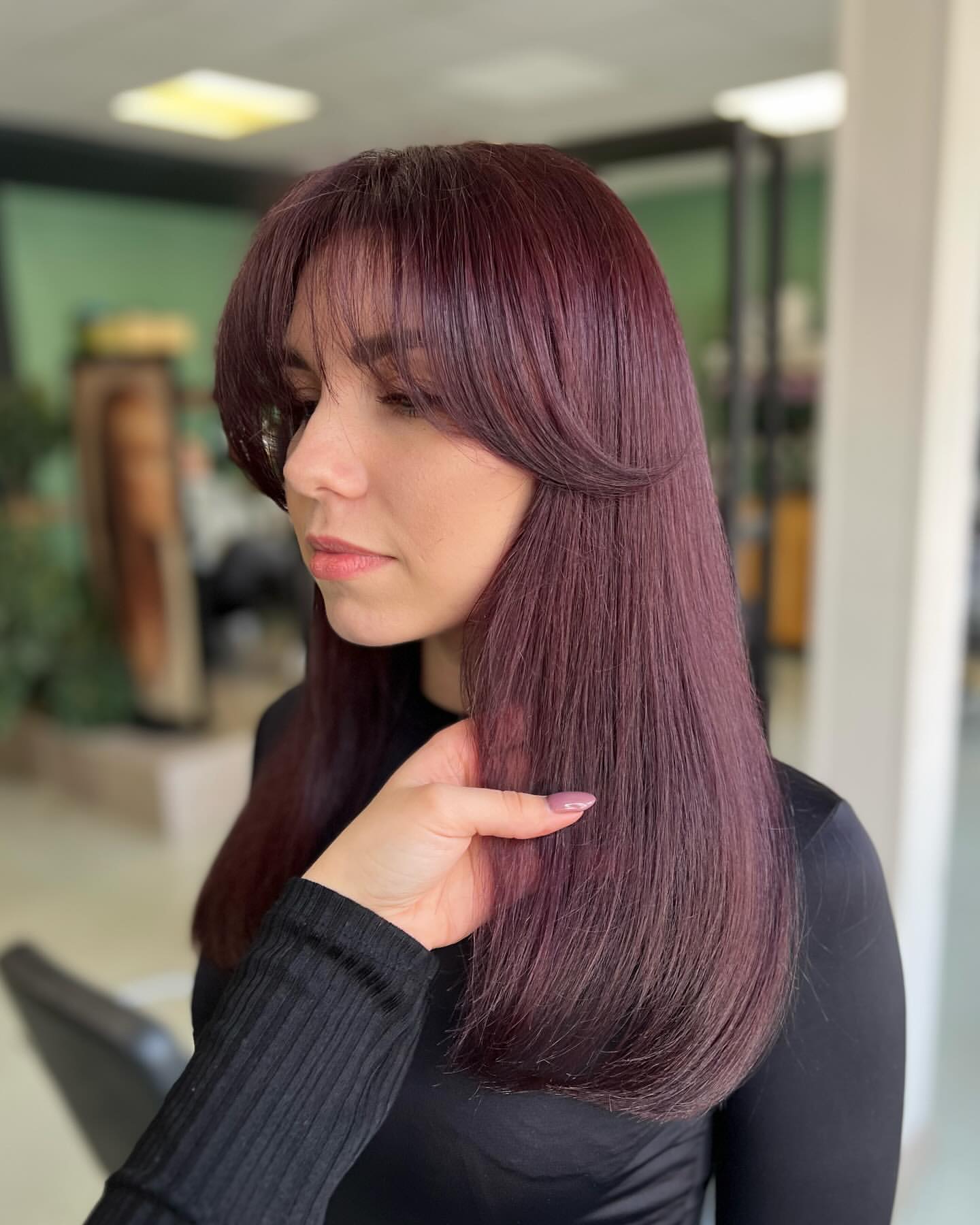 dark burgundy hair with curtain bangs