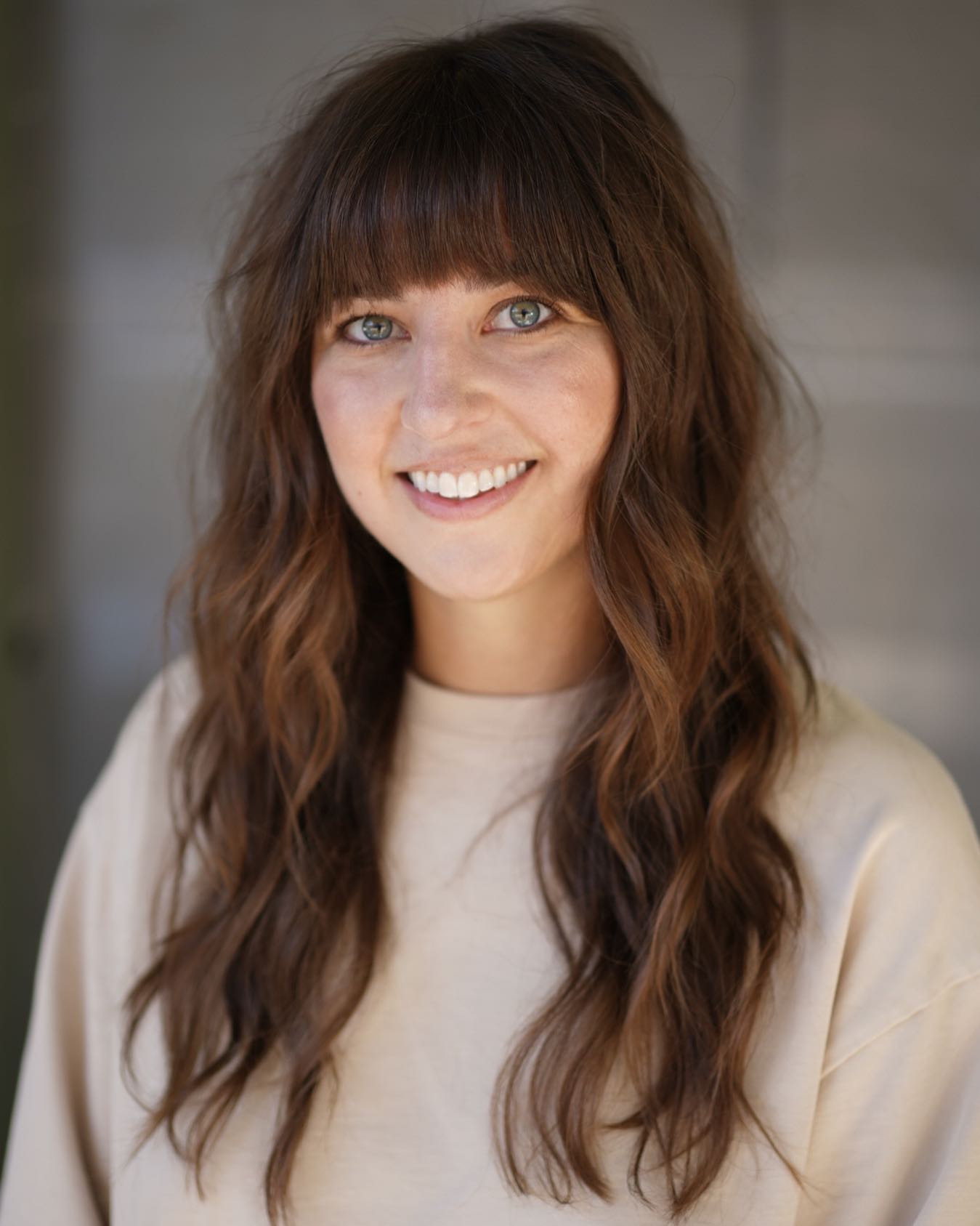 long textured hair with blunt bangs