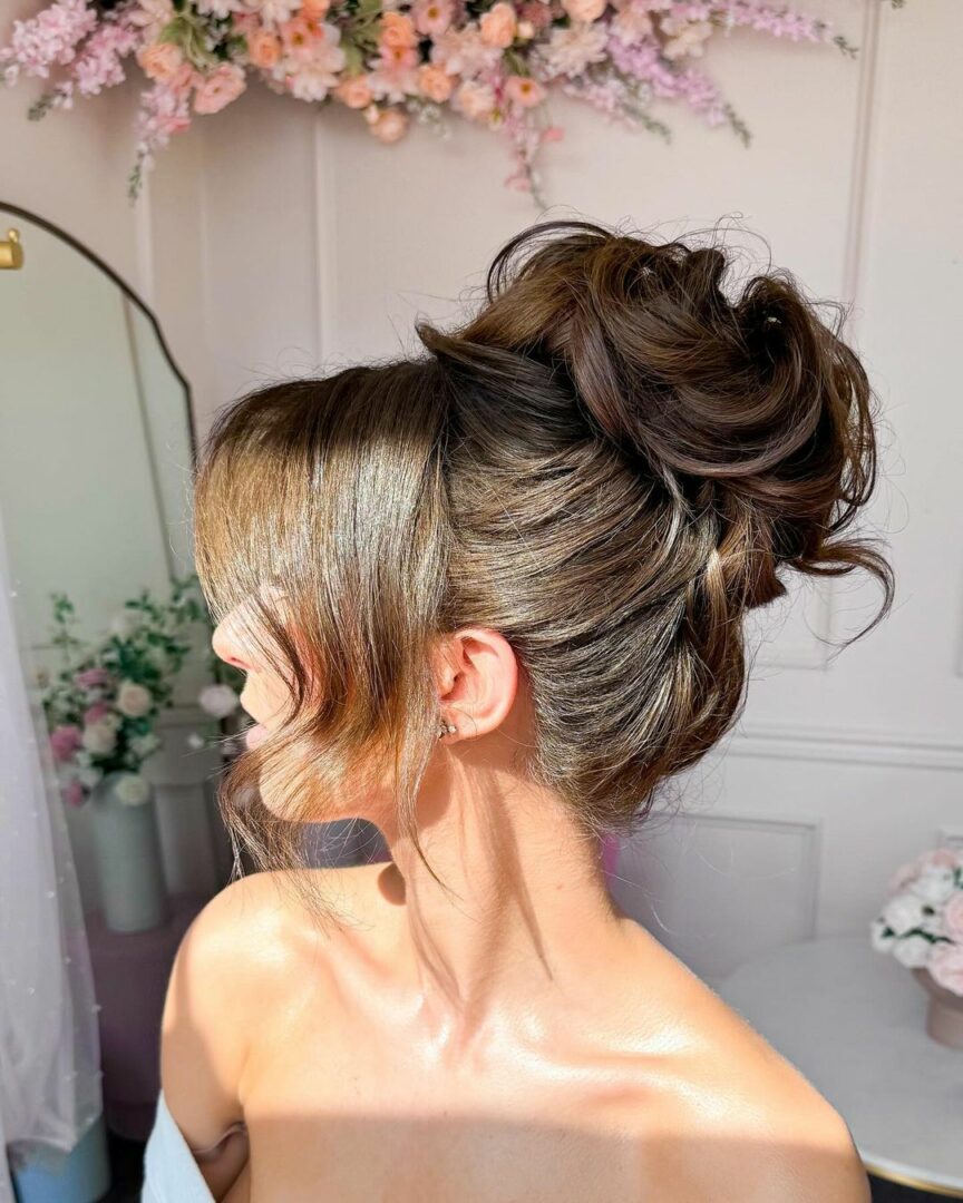 High bun with face-framing pieces showcasing metallic hair