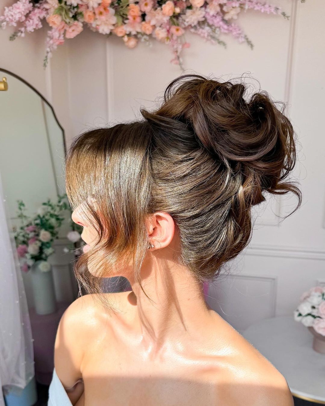 High Messy Bun With Face-Framing Pieces