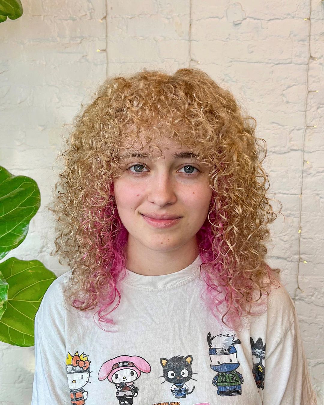 blonde curls with pink peekaboo highlights