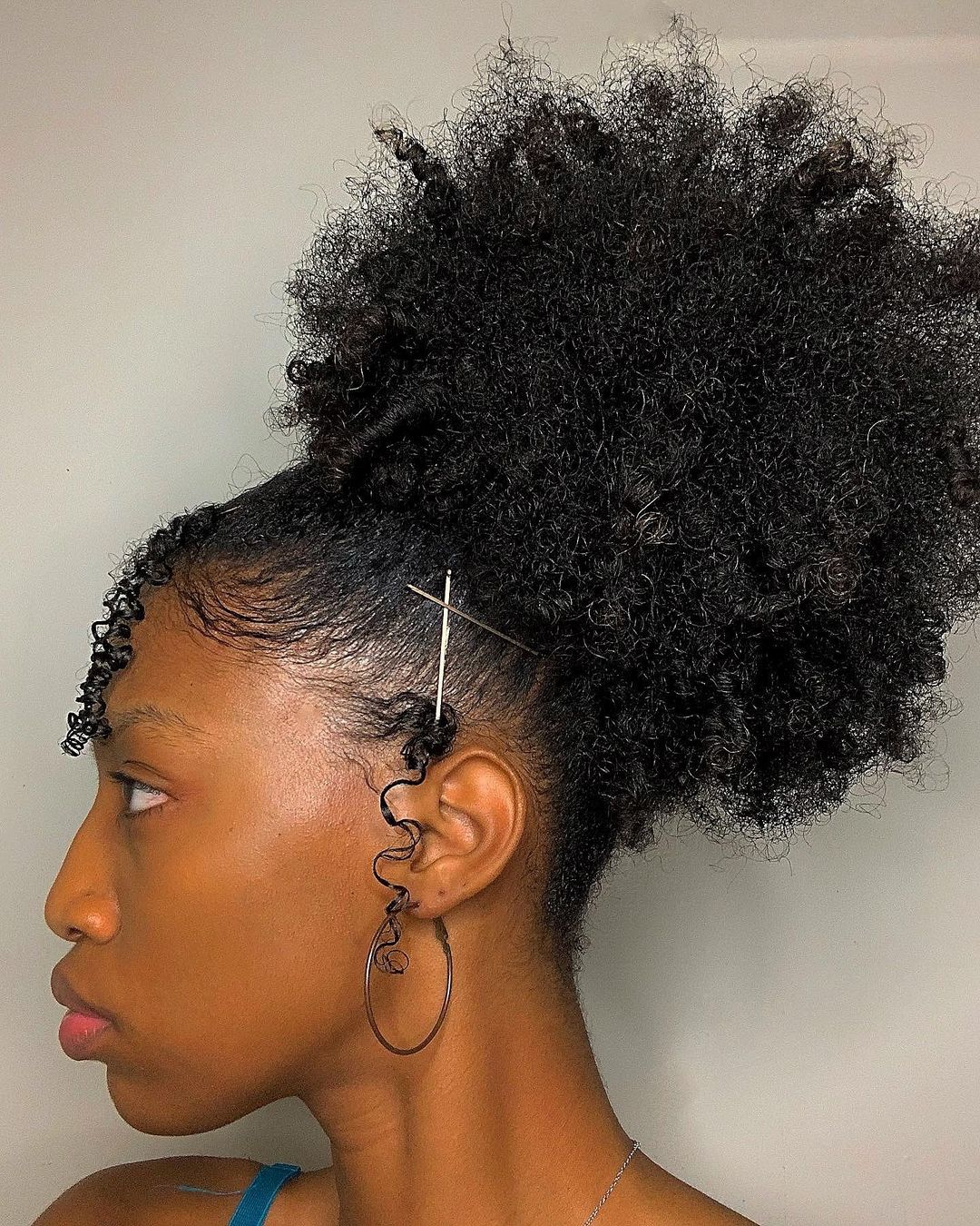 curly massive bun with sleek hair on the crown