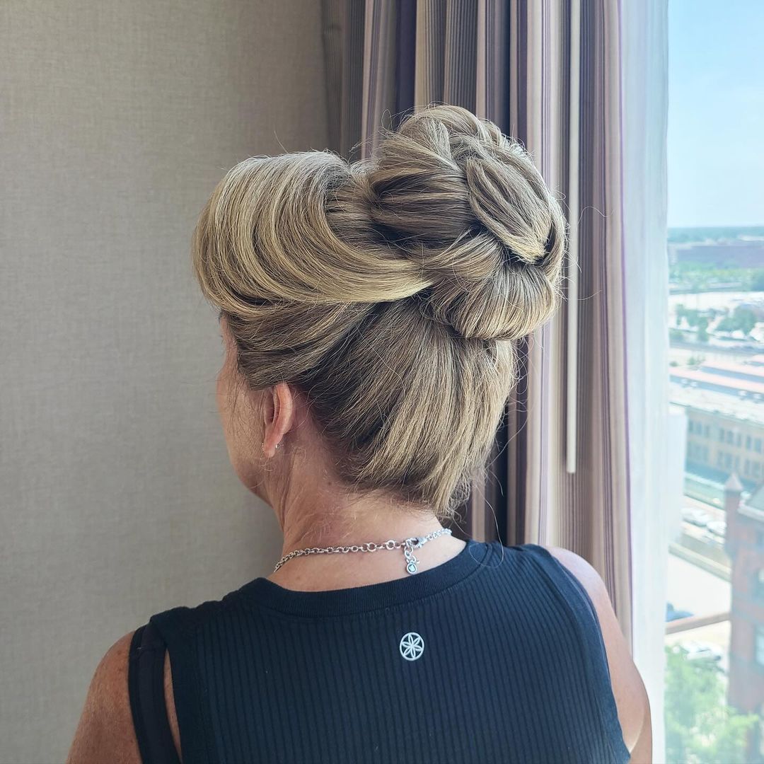 elegant high bun with side-swept bangs