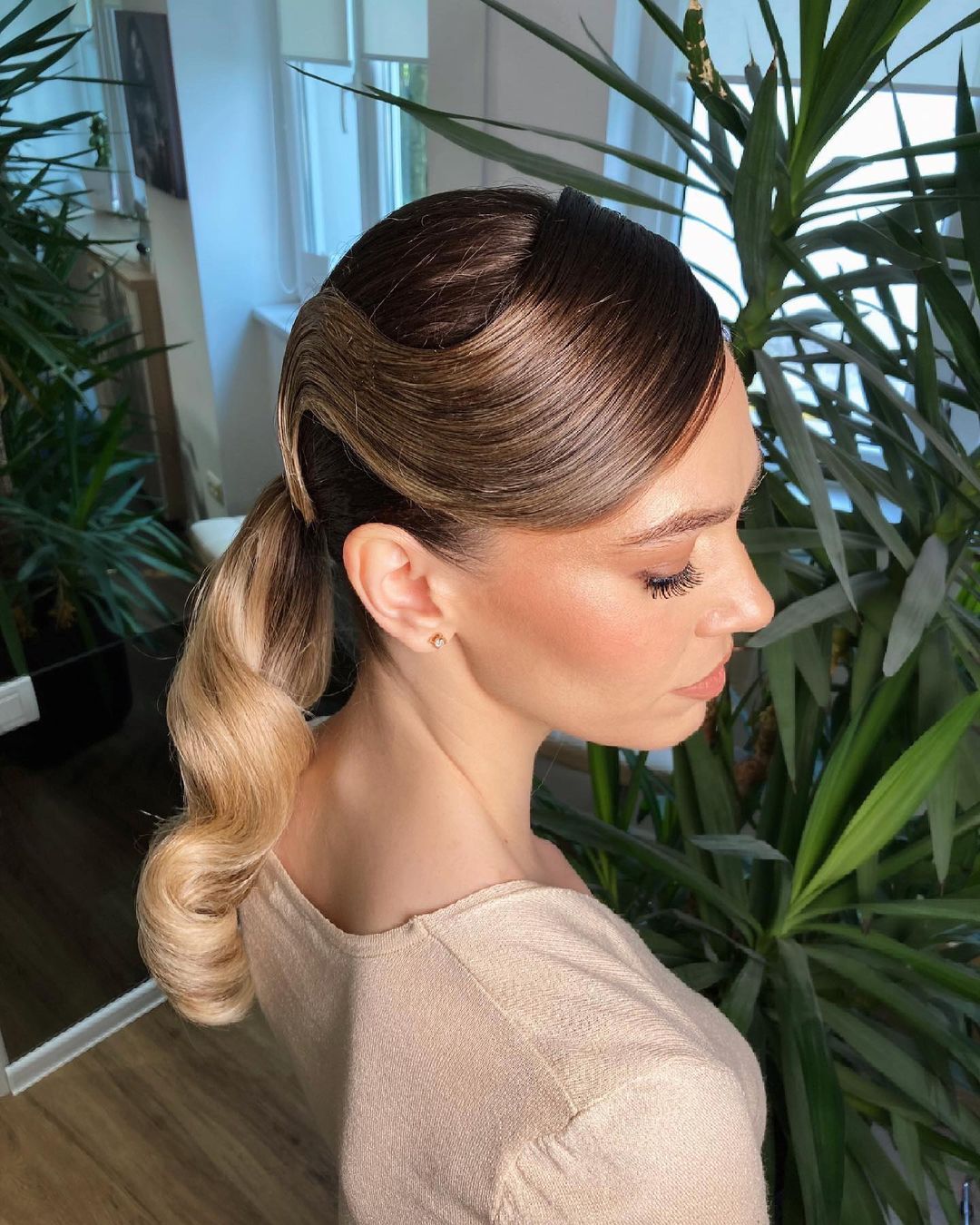 low ponytail with side-swept bangs