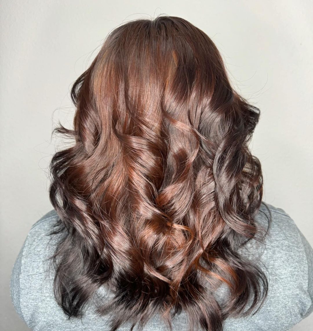 medium dark brown hair with copper undertones