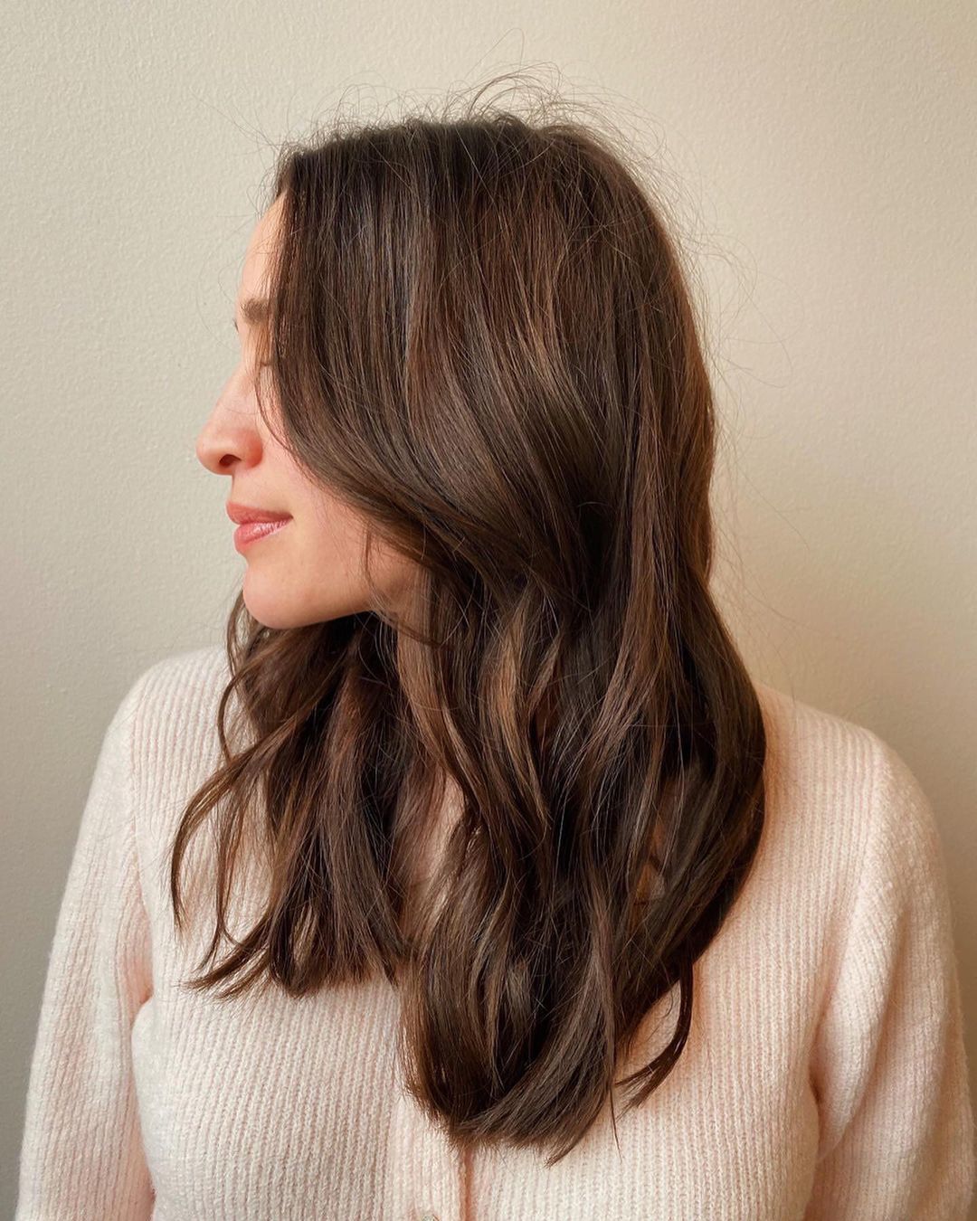 medium wavy brunette with soft highlights