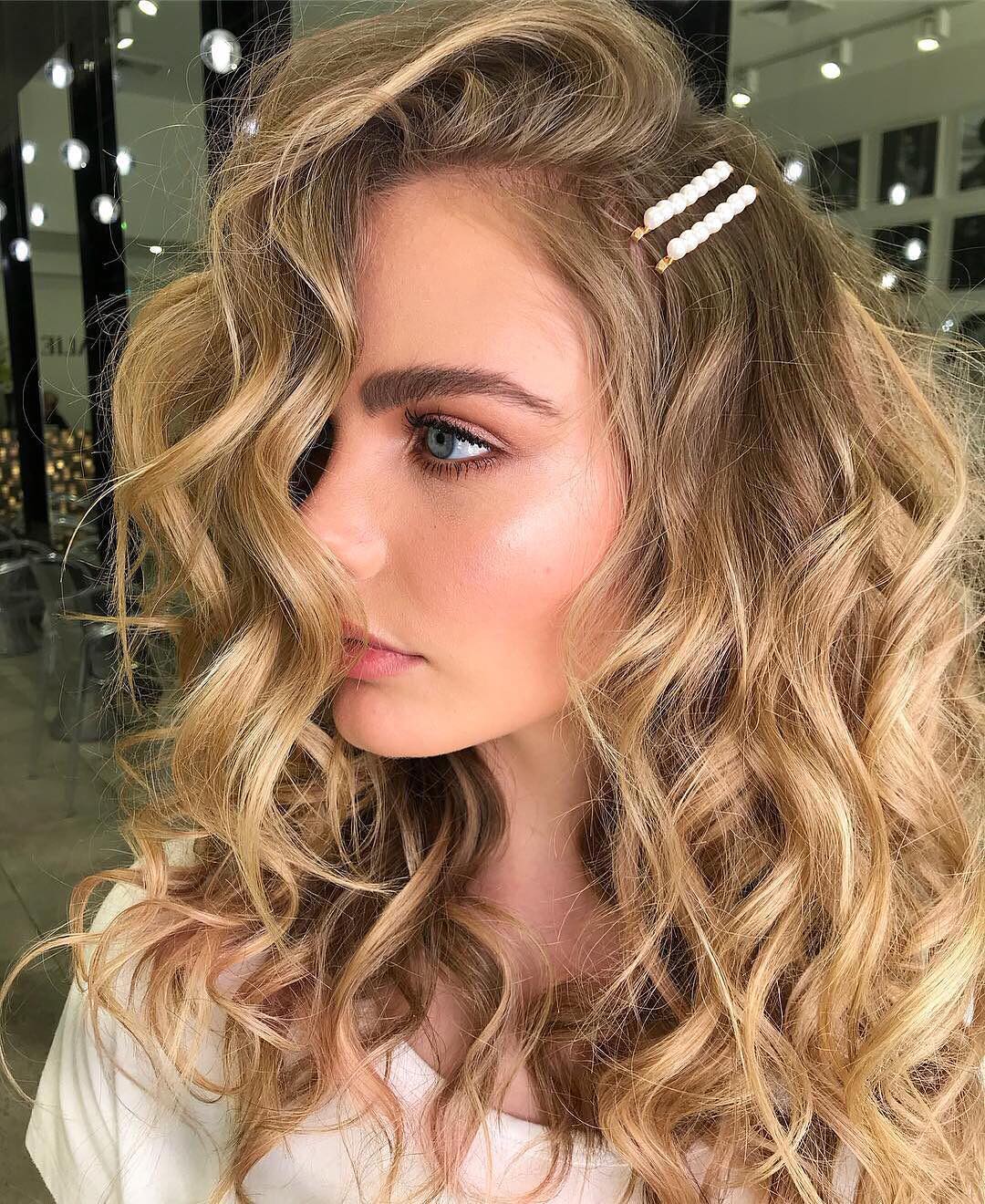 side parted messy waves with hair pins