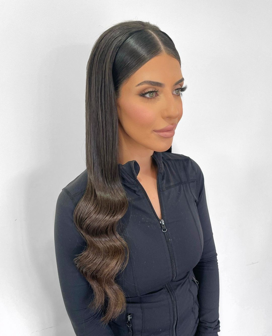 sleek back hairstyle with loose waves