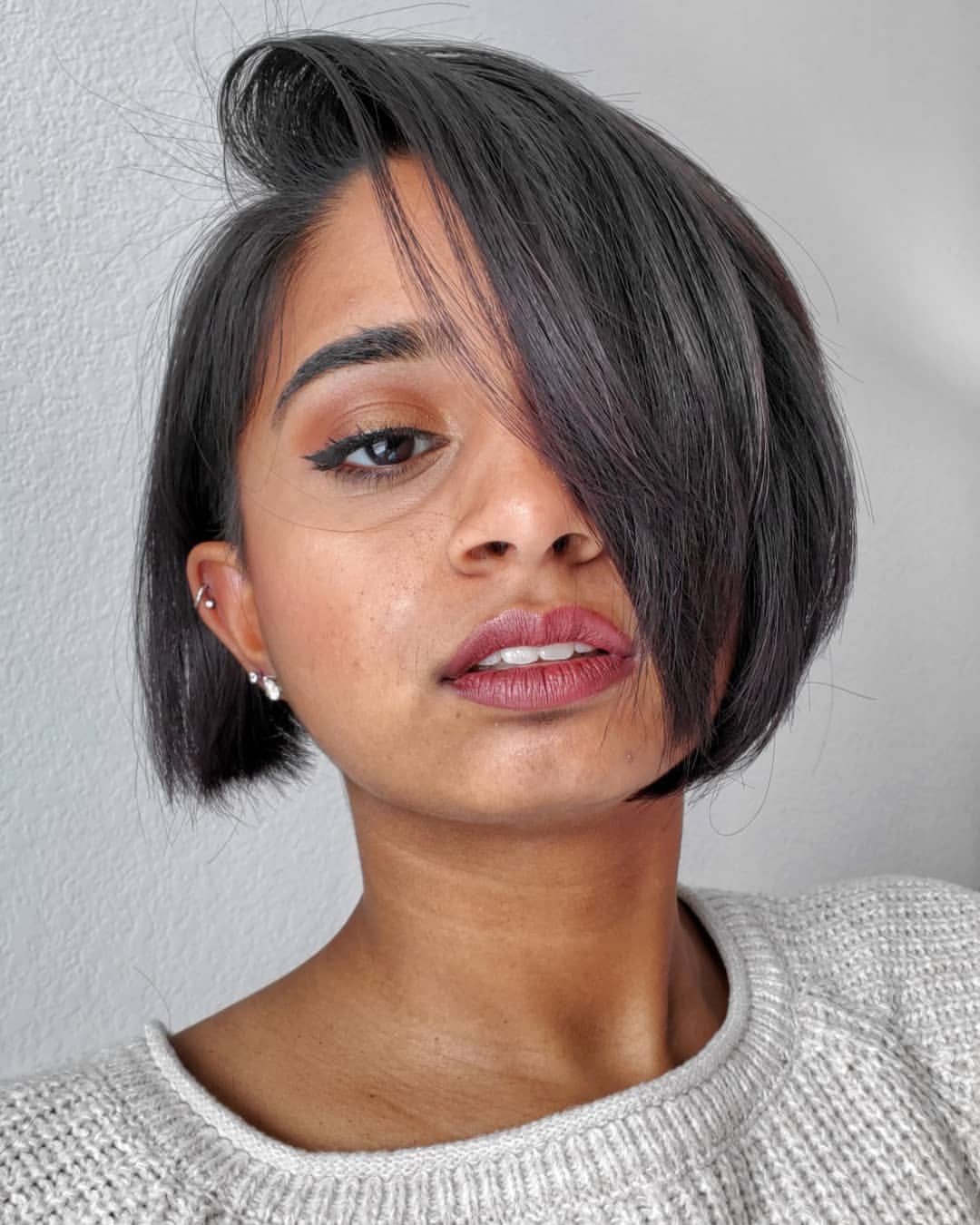 sleek side part on a long pixie