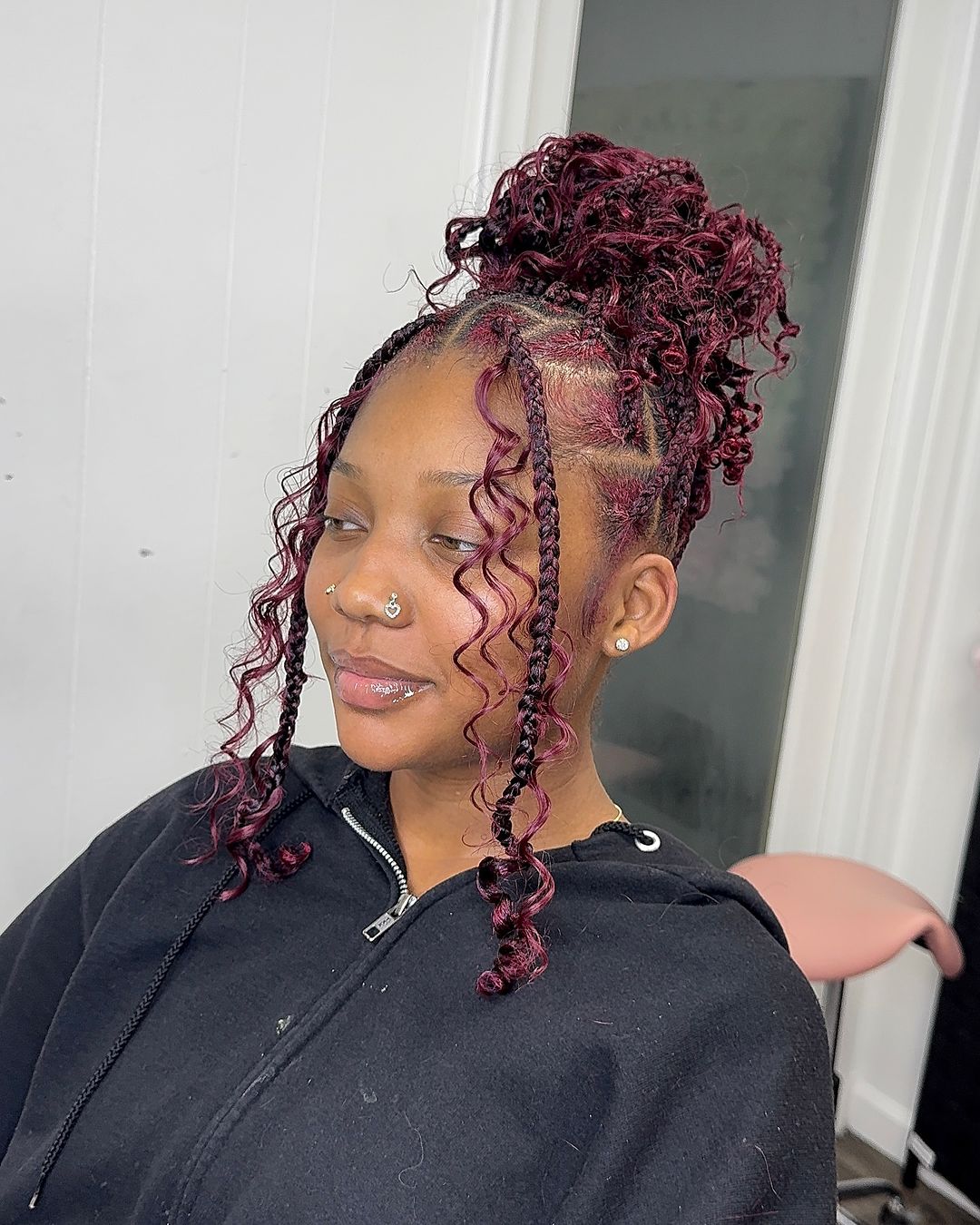 burgundy knotless braids in a high bun