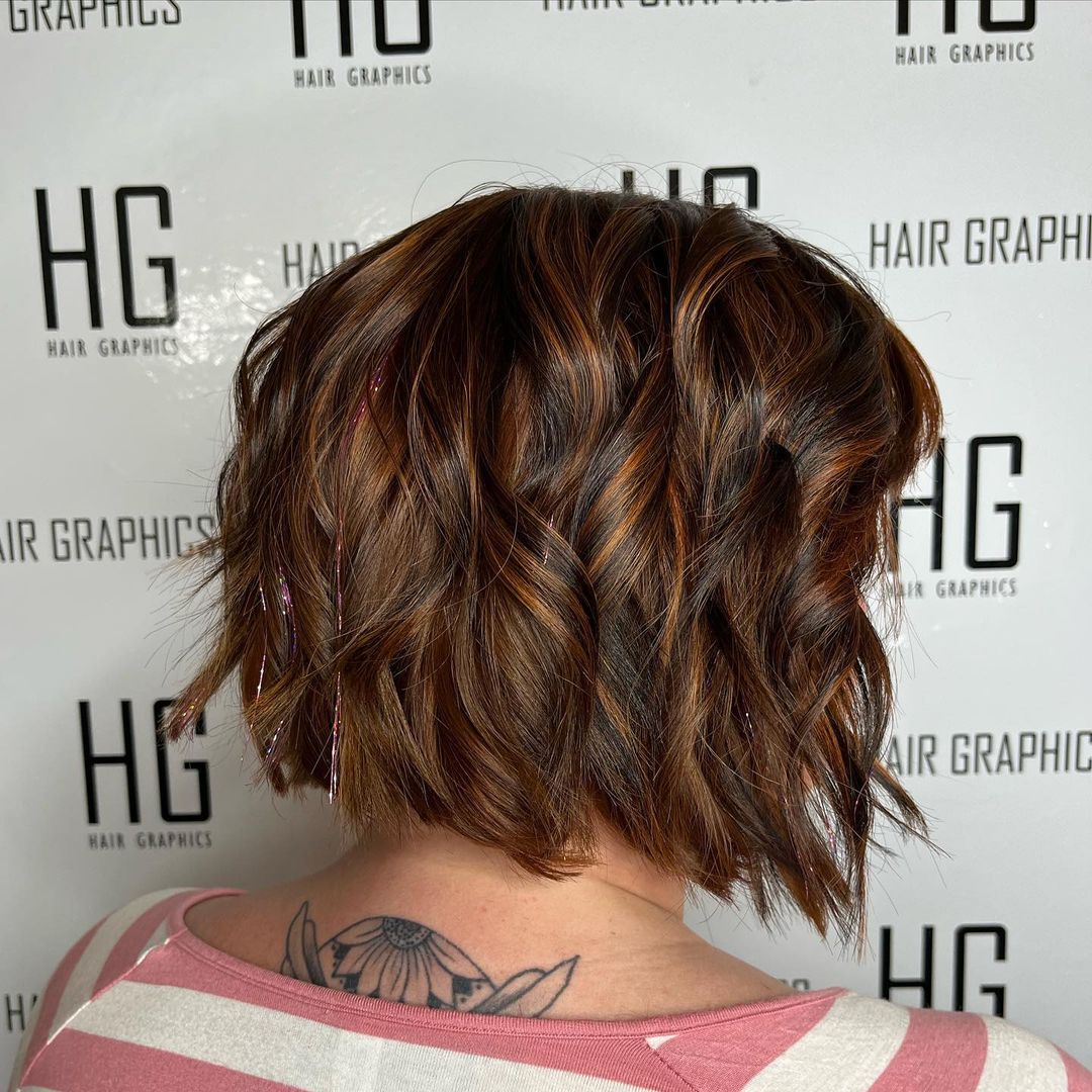 chin-length wavy bob with copper highlights