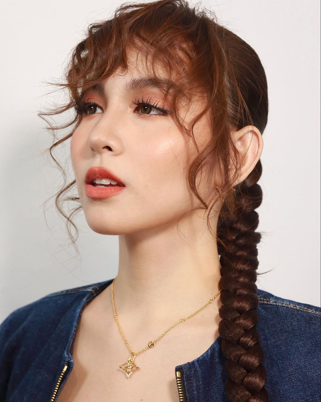 curly bangs with a sleek braid