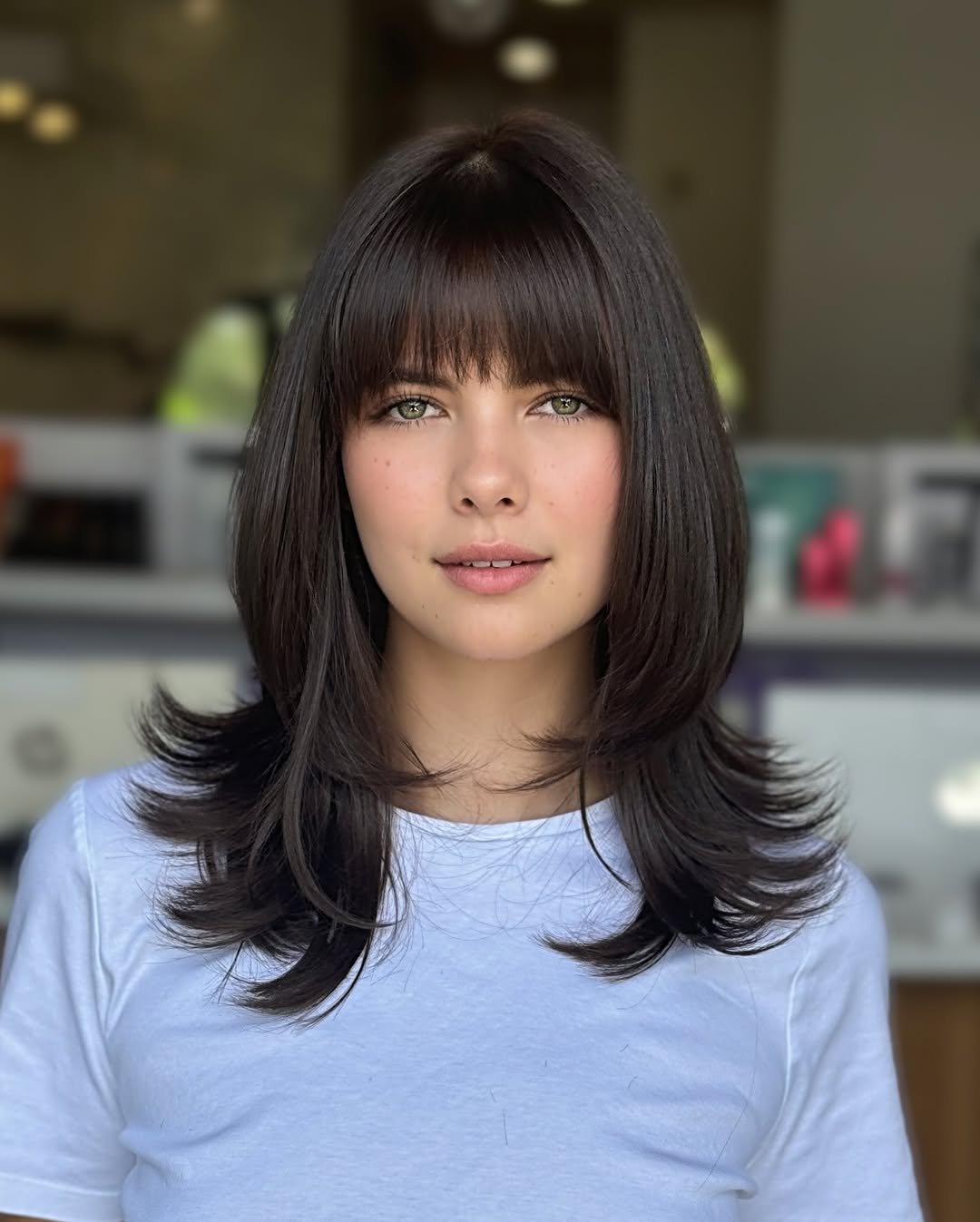 flicked medium length haircut with bangs