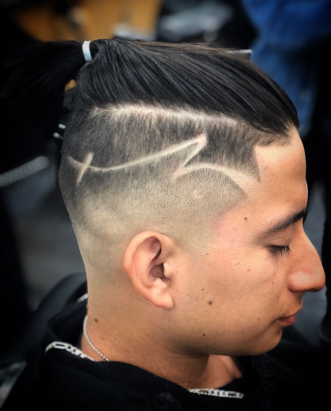 man bun fade with a hair design