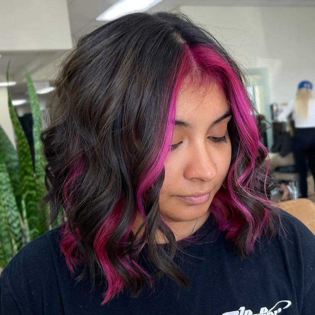 dark wavy lob with face-framing magenta highlights