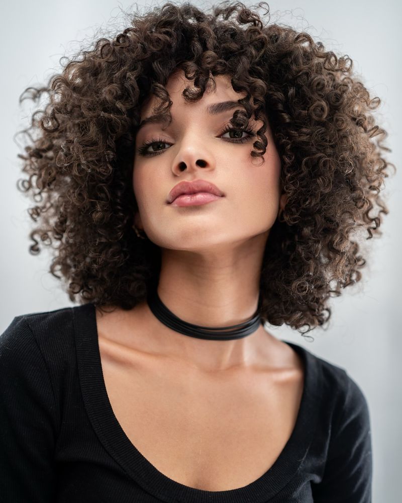 Voluminous Curls with Side-swept Bangs