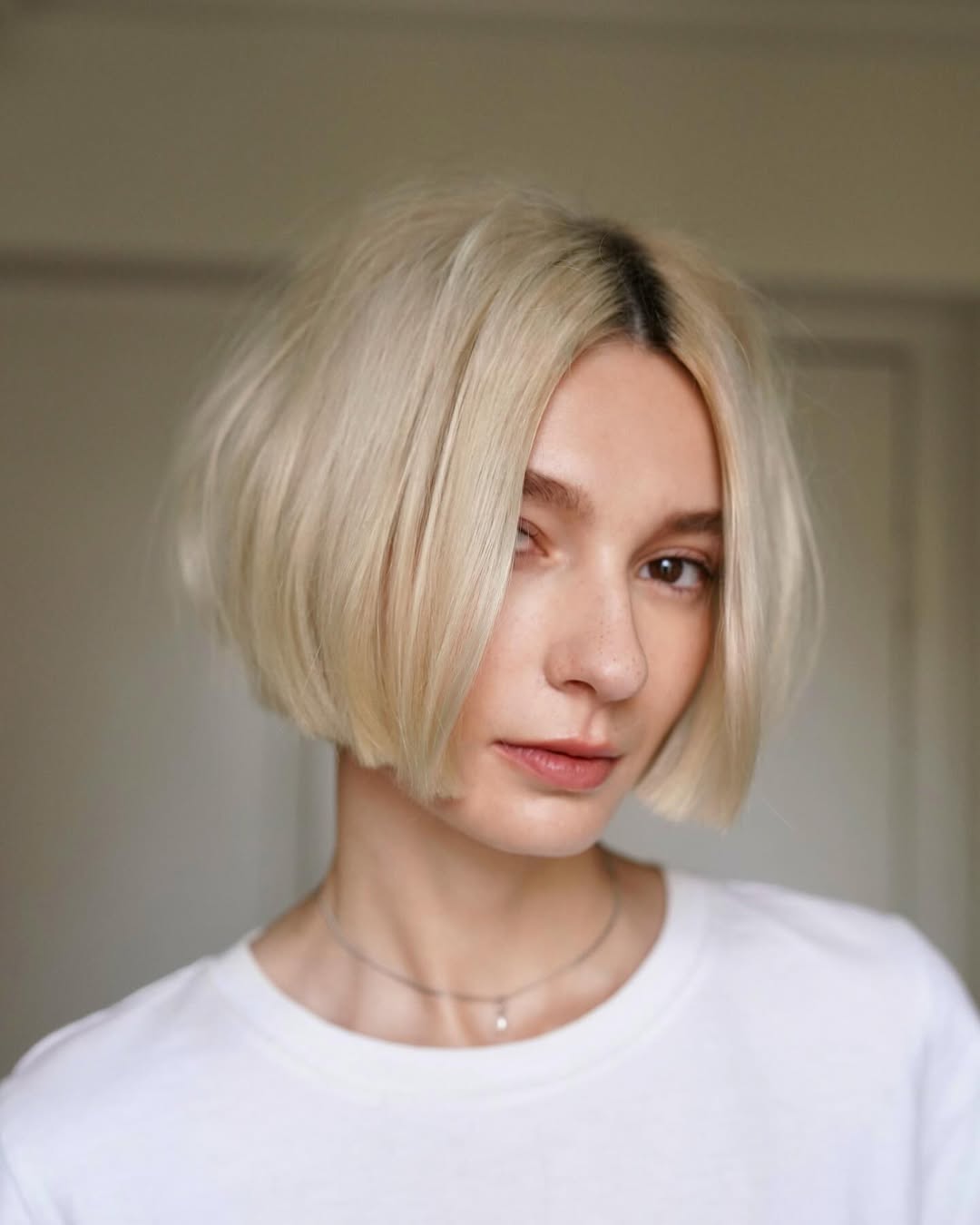 blonde blunt bob with dark roots