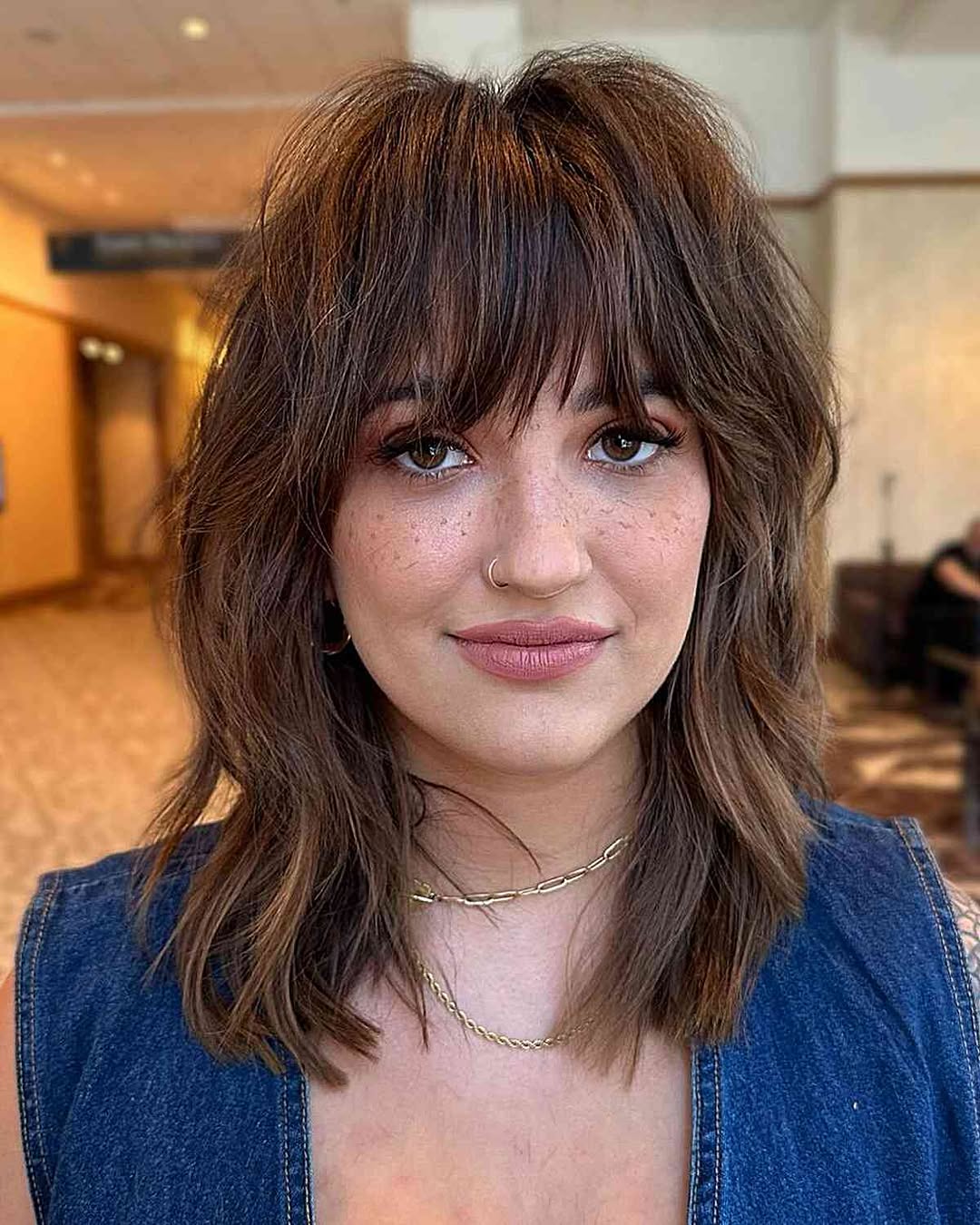 shaggy haircut with bottleneck bangs