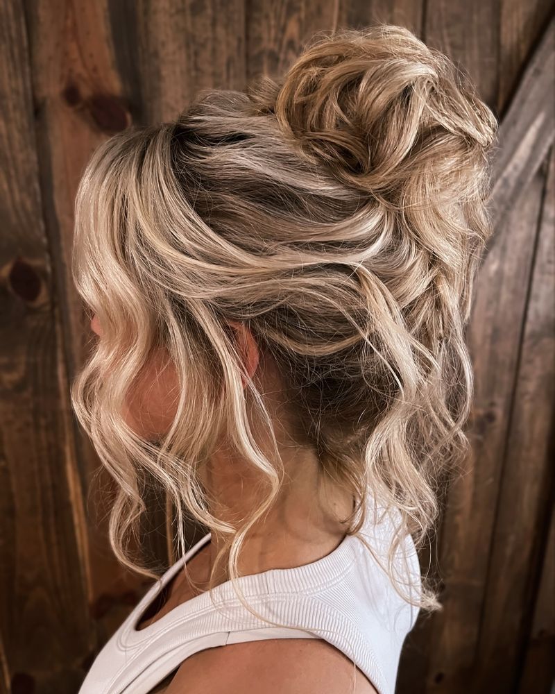 High Messy Bun with Face-Framing Tendrils