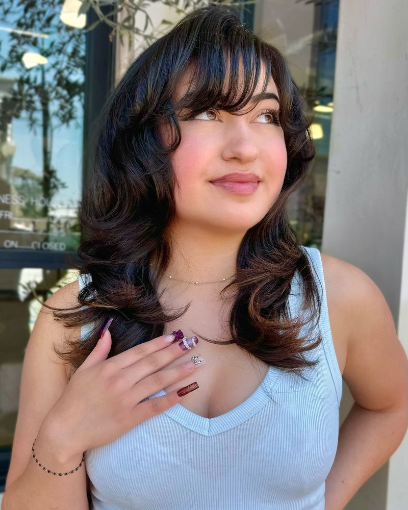 Voluminous Layers with Side-Swept Bangs