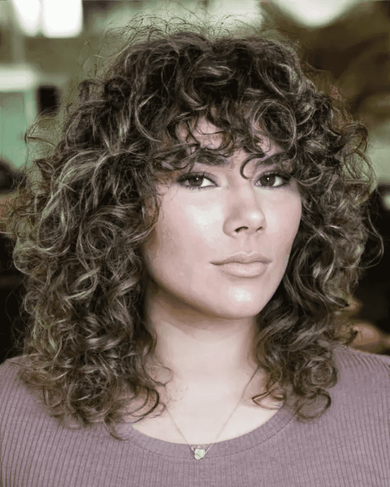 Curly Shoulder-Length Cut with Bangs
