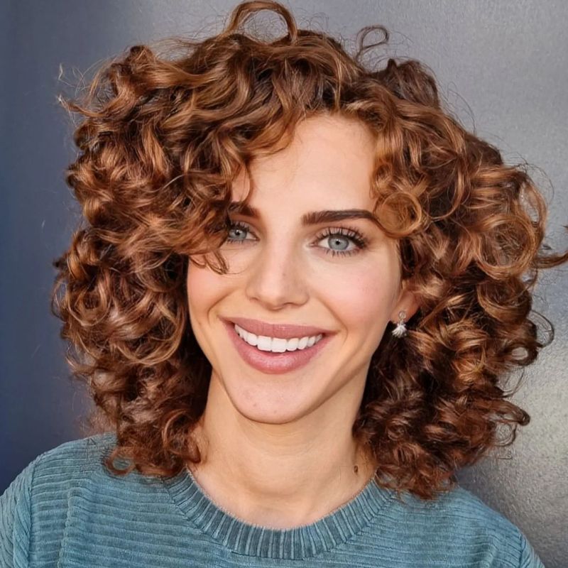 Mid-Length Curls with Side-Swept Bangs